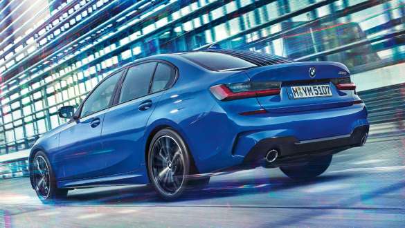 Three-quarter rear view of the driving BMW 3 Series Sedan with Adaptive M suspension.