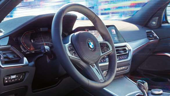 Detailed side view of the cockpit of the BMW 3 Series Sedan with focus on the steering wheel with variable sport steering.