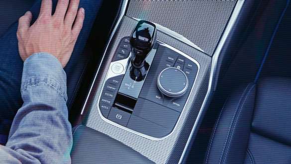 Detailed bird's eye view of the centre console of the BMW 3 Series Sedan with gear lever and Steptronic Sport transmission.