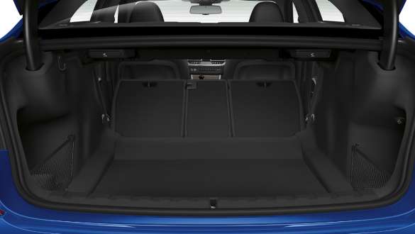 Close-up of the opened trunk with the rear backseats half folded down.