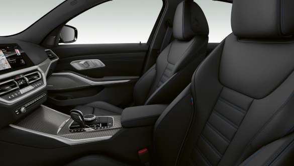 Close-up side view of the front row seats with black sport seats for driver and front passenger.