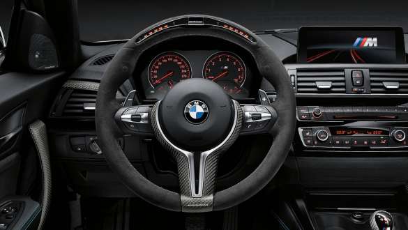 Close-up view of the BMW 3 Series Sedan with focus on the BMW M Performance Parts steering wheel II Alcantara with carbon fibre trim.